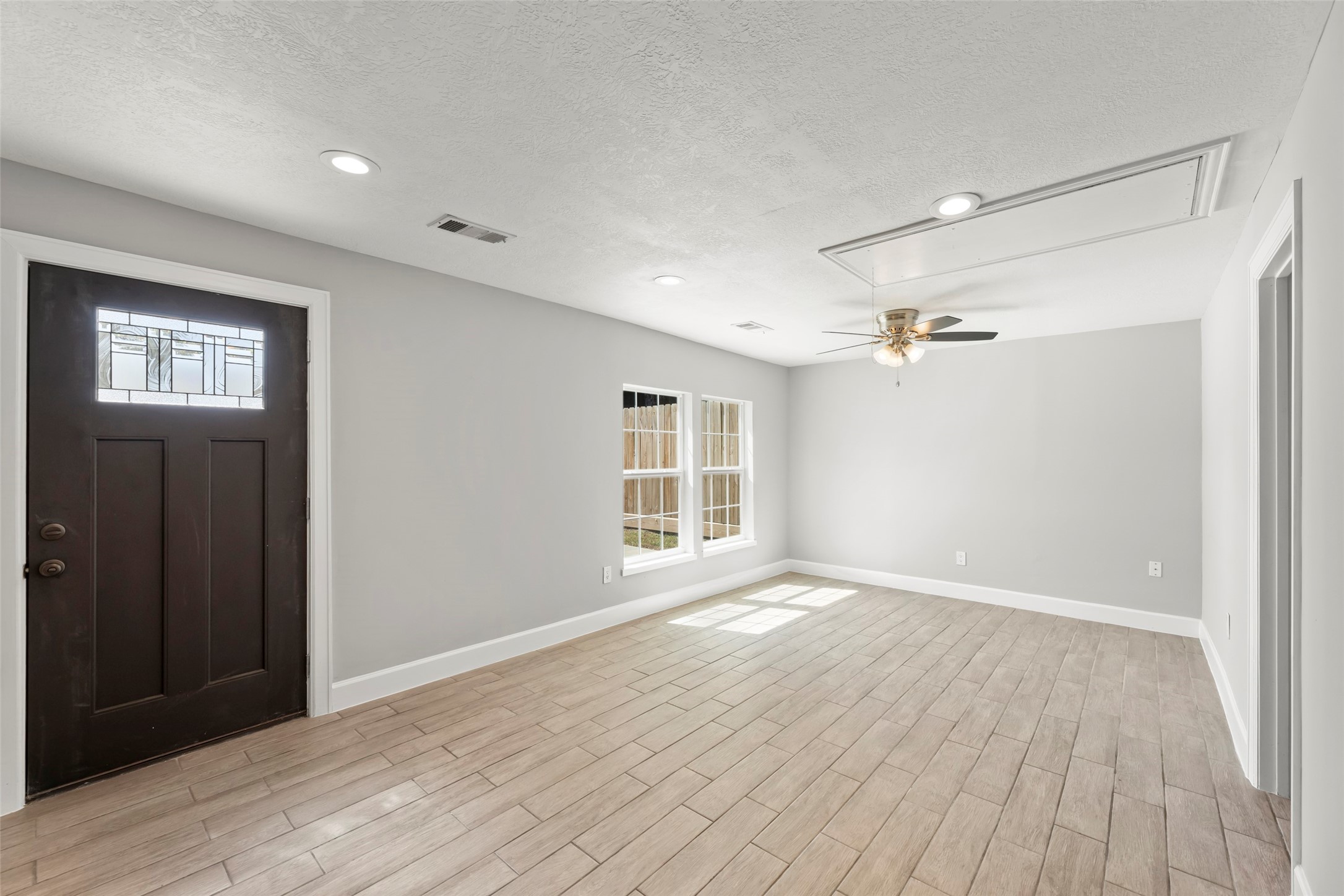 729 Caperton Street Houston, TX 77022 - Photo 29 of 42 a view of an empty room with wooden floor and a window