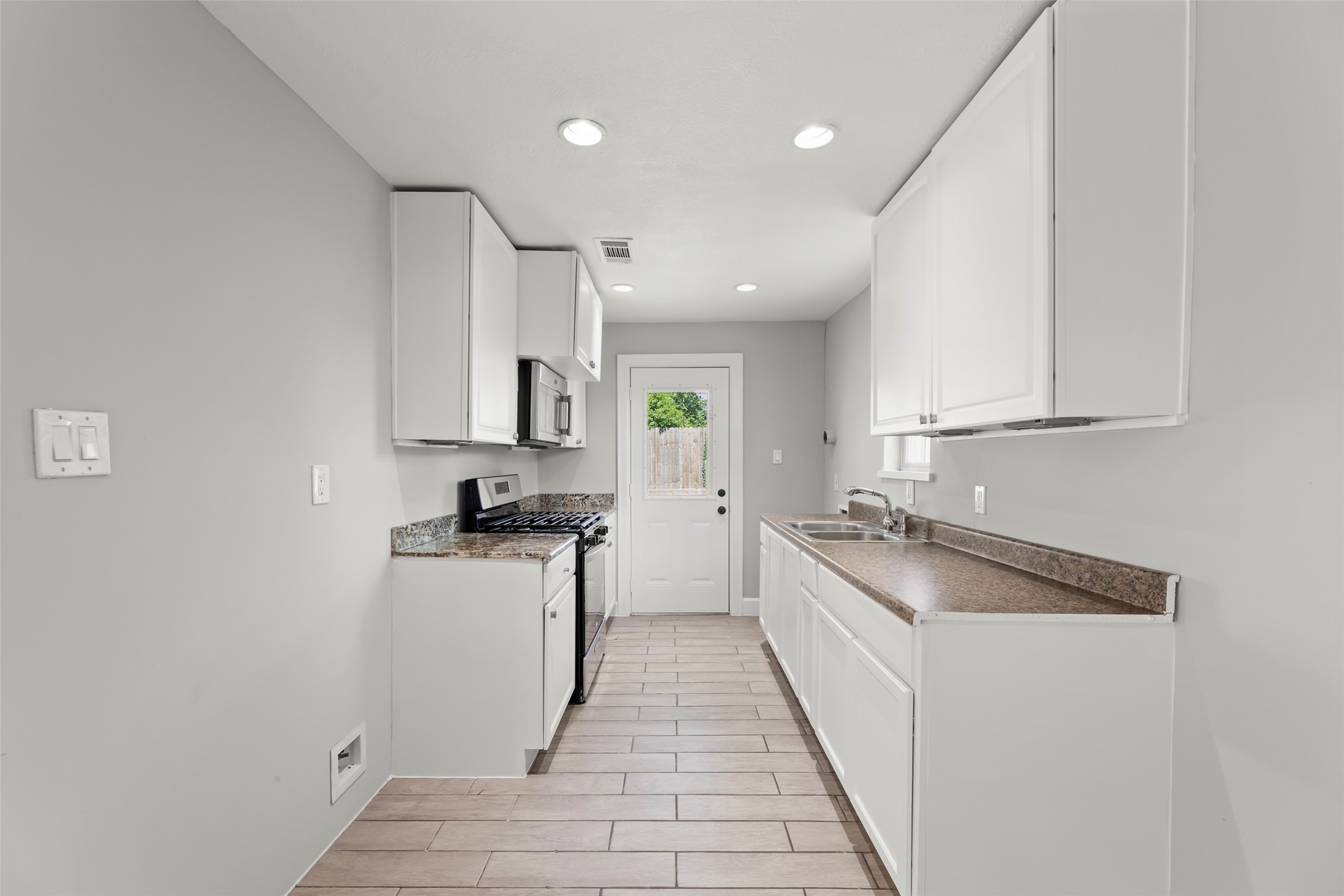 729 Caperton Street Houston, TX 77022 - Photo 31 of 42 a kitchen with a stove and a sink