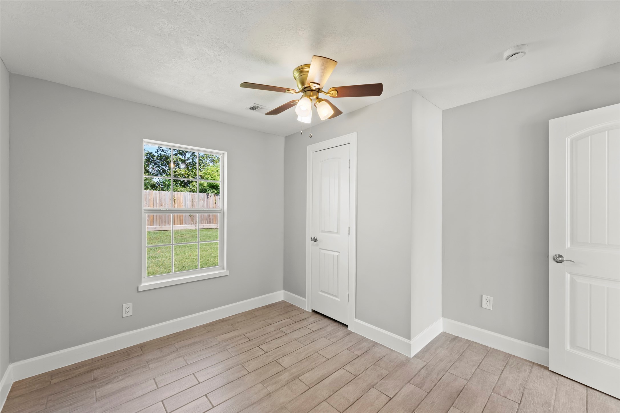 729 Caperton Street Houston, TX 77022 - Photo 37 of 42 wooden floor in an empty room with a window