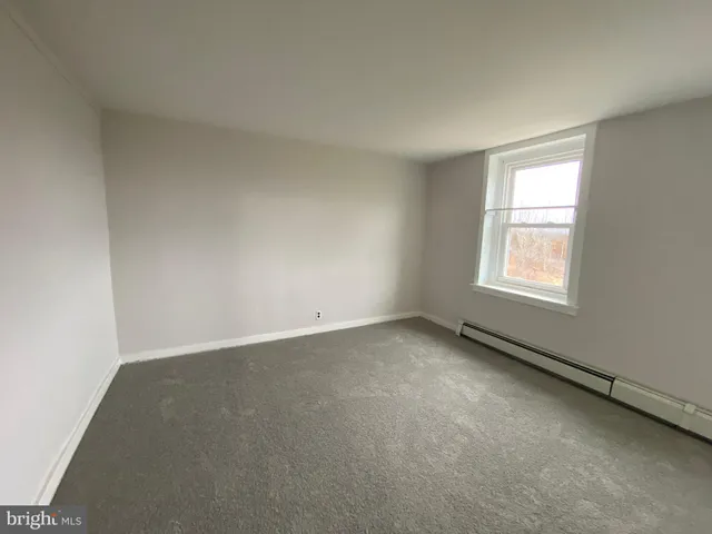 an empty room with windows and entrance