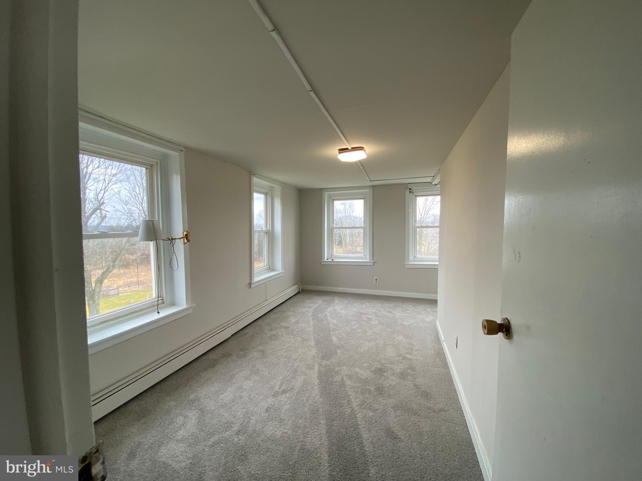 2063 Hill Road, Unit B Perkiomenville, PA 18074 - Photo 15 of 27 a view of an empty room with a window