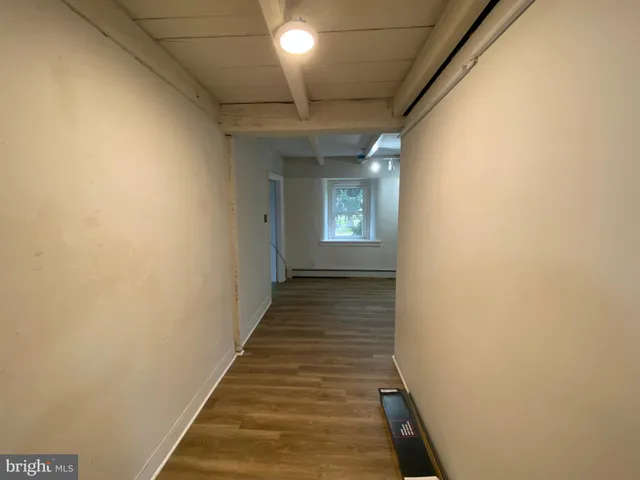 a view of a room with wooden floor