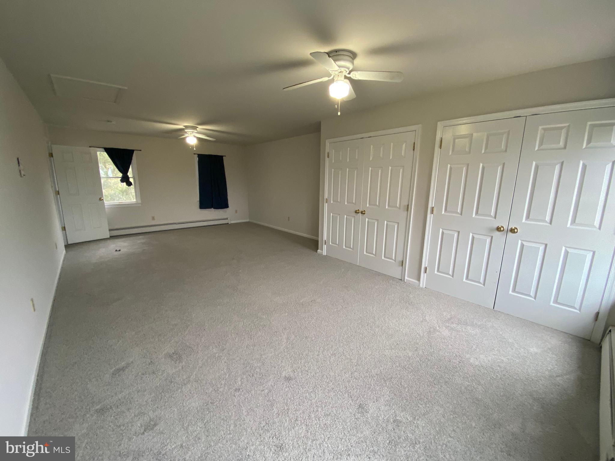 2063 Hill Road, Unit B Perkiomenville, PA 18074 - Photo 22 of 27 an empty room with windows and fan