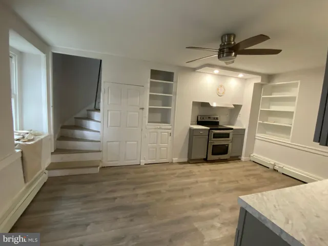 a view of a kitchen with furniture and an empty room