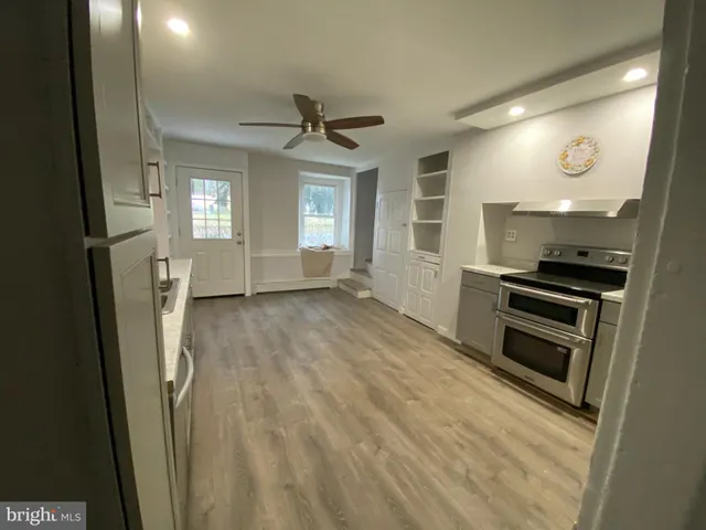 a view of kitchen with sink and refrigerator