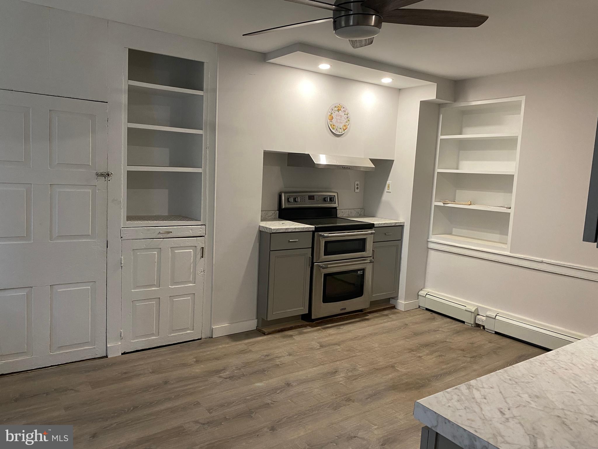 2063 Hill Road, Unit B Perkiomenville, PA 18074 - Photo 6 of 27 a kitchen with white cabinets and a stove top oven