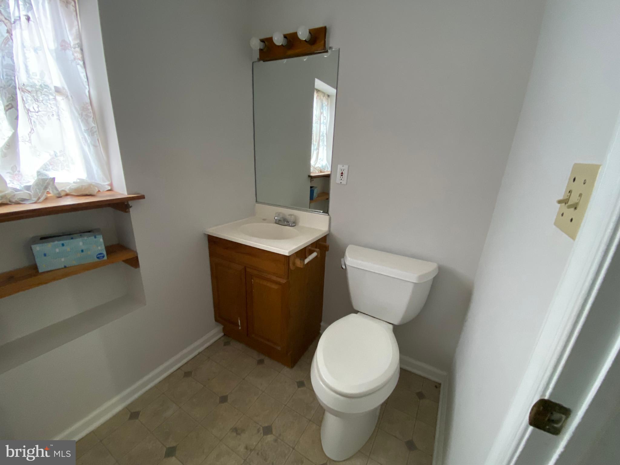 2063 Hill Road, Unit B Perkiomenville, PA 18074 - Photo 8 of 27 a white toilet sitting next to a bathroom sink