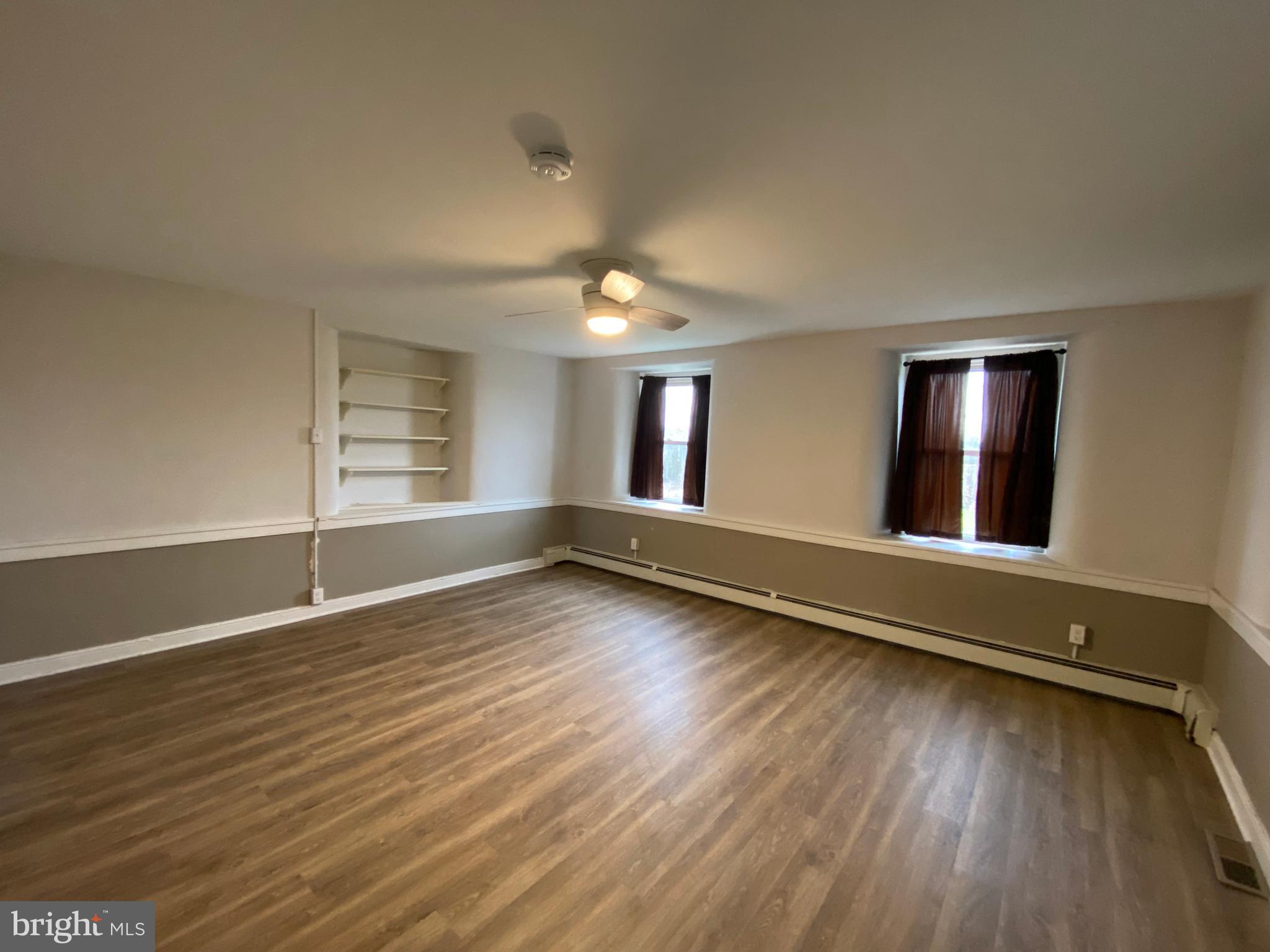 2063 Hill Road, Unit B Perkiomenville, PA 18074 - Photo 9 of 27 an empty room with wooden floor and windows