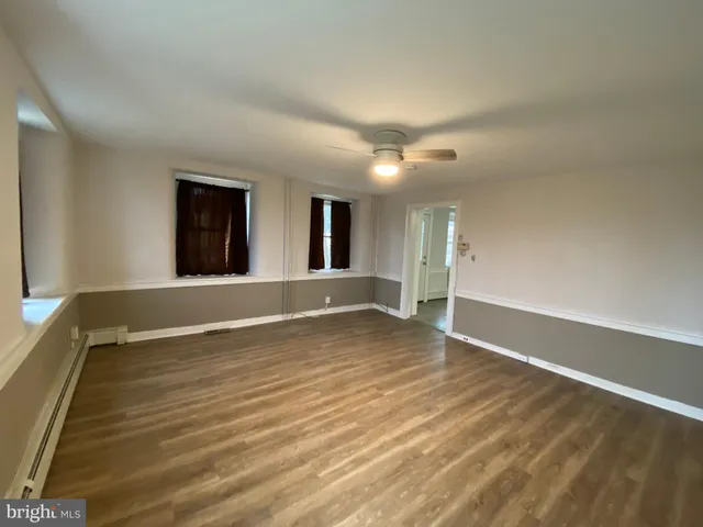 a kitchen with a sink cabinets and wooden floor