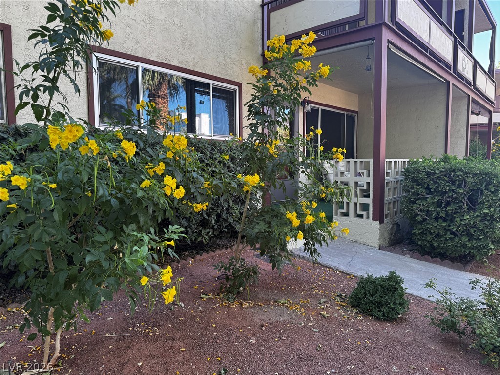 350 East Desert Inn Road, Unit C103 Las Vegas, NV 89109 - Photo 1 of 23 A well-maintained garden path guides you to a cozy ground-floor patio, perfect for relaxing outdoors.