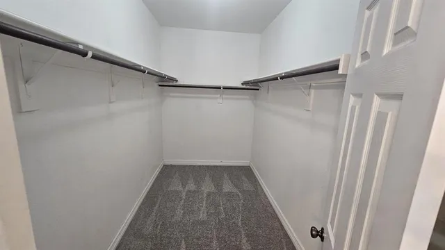 a view of a room with wooden floor and a window