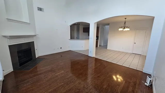 wooden floor in an empty room with a fireplace
