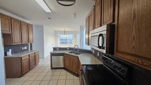 a kitchen with a sink stove and microwave