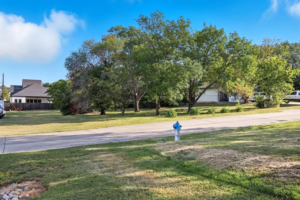 Tbd East 2nd Street Prosper, TX 75078 - Photo 16 of 20 a view of a swimming pool with a house in the background