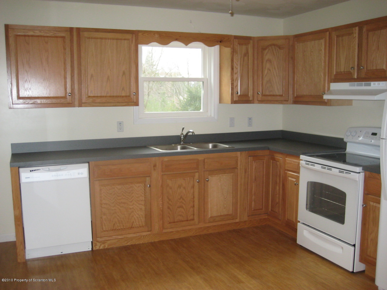 59 John Sheehan Road Mehoopany, PA 18629 - Photo 4 of 9 a kitchen with granite countertop white cabinets and sink