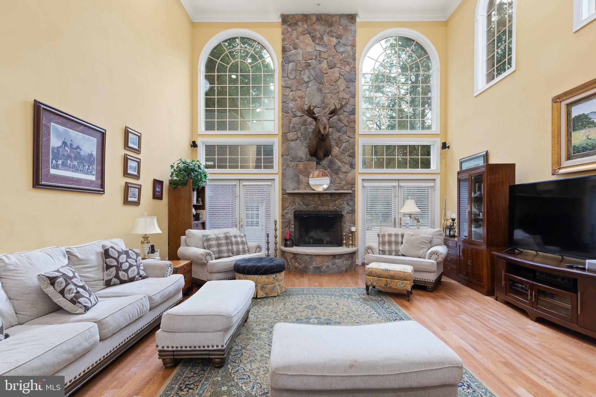 5530 Jim Pickett Road Sykesville, MD 21784 - Photo 12 of 49 a living room with furniture a fireplace and a flat screen tv