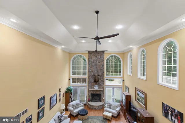 a very nice looking living room with a large window and a fireplace