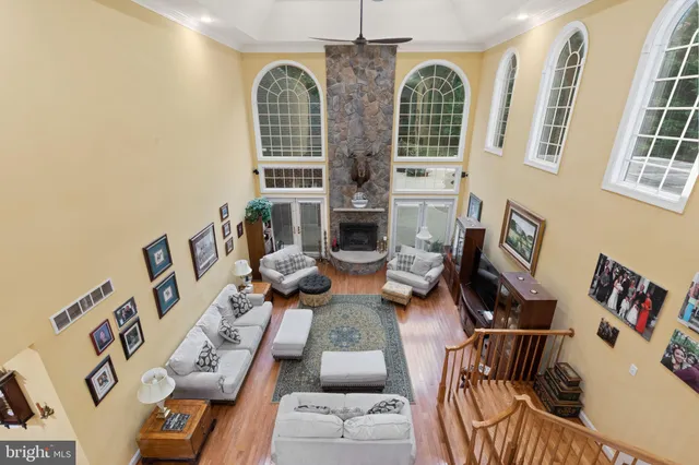 a living room with furniture fireplace and wooden floor