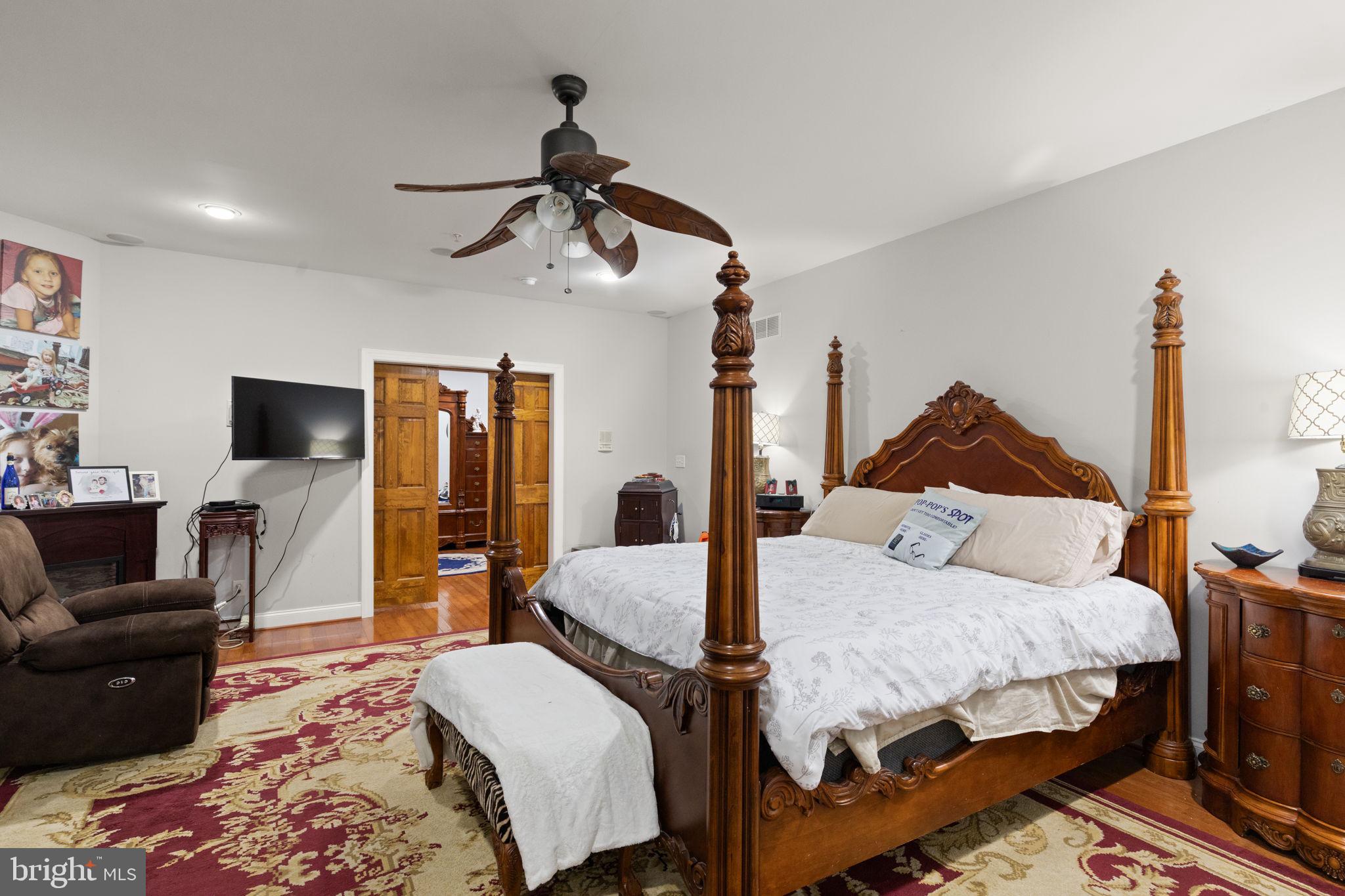 5530 Jim Pickett Road Sykesville, MD 21784 - Photo 20 of 49 a bedroom with a bed a couch and a flat tv screen