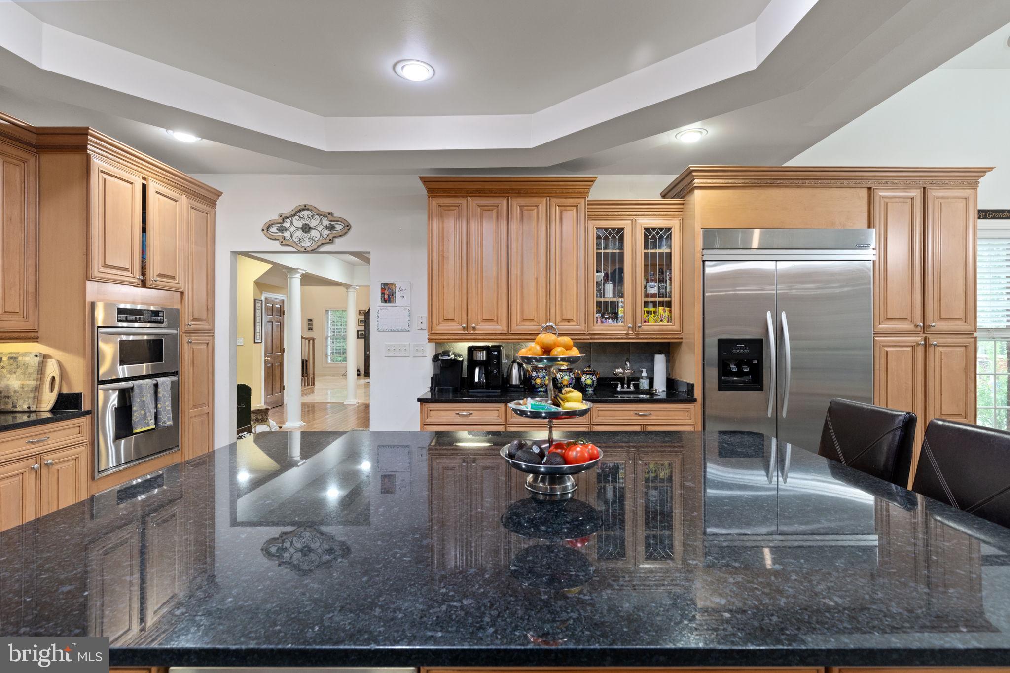 5530 Jim Pickett Road Sykesville, MD 21784 - Photo 25 of 49 a kitchen with stainless steel appliances granite countertop a refrigerator dining table and chairs