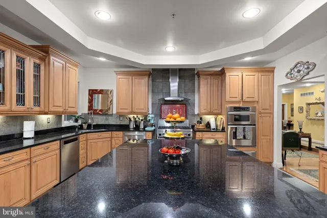 a kitchen with lots of counter top space a sink appliances and cabinets