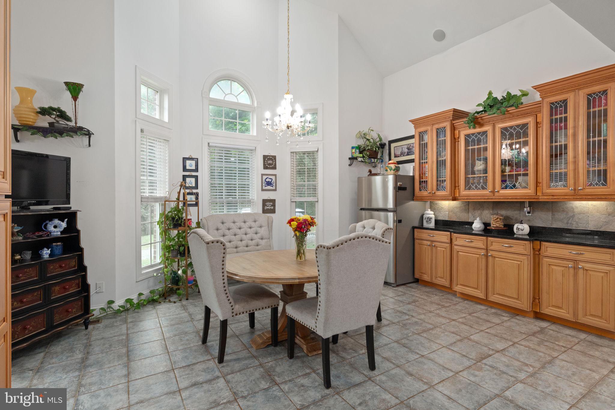 5530 Jim Pickett Road Sykesville, MD 21784 - Photo 28 of 49 a view of a dining room with furniture and chandelier