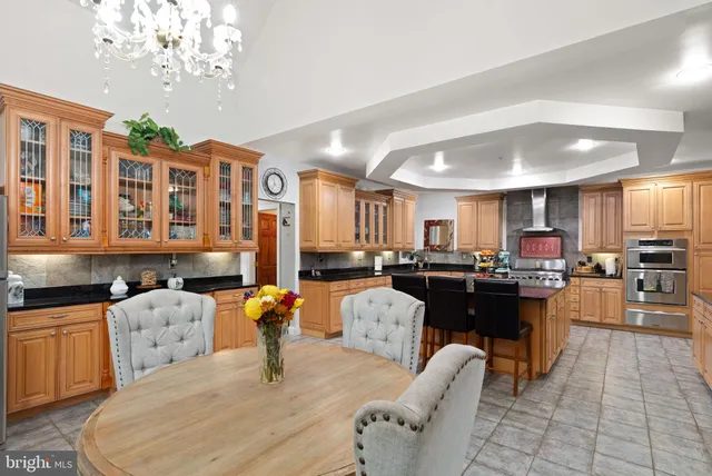 a large kitchen with a table and chairs