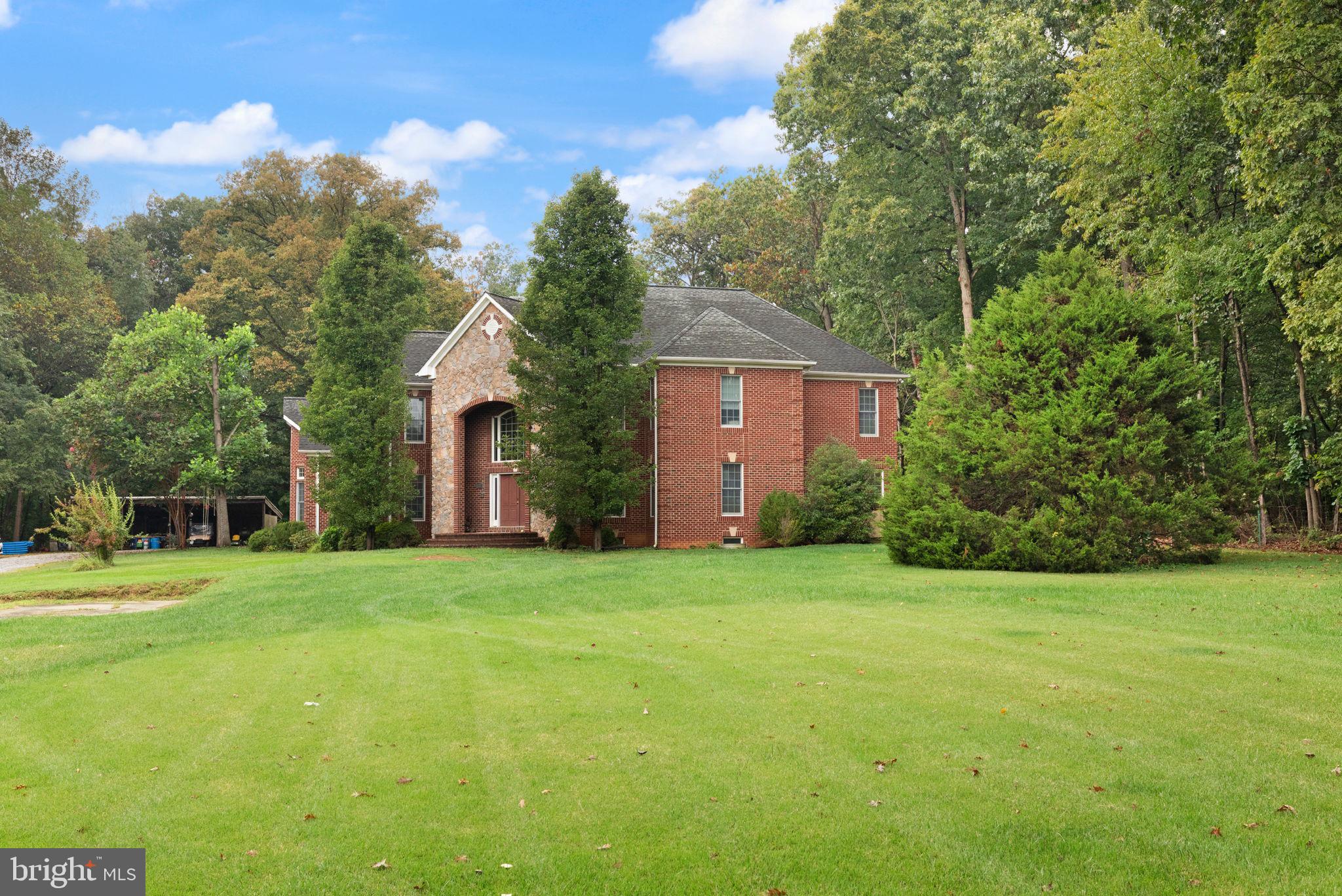 5530 Jim Pickett Road Sykesville, MD 21784 - Photo 3 of 49 a front view of a house with a yard and trees