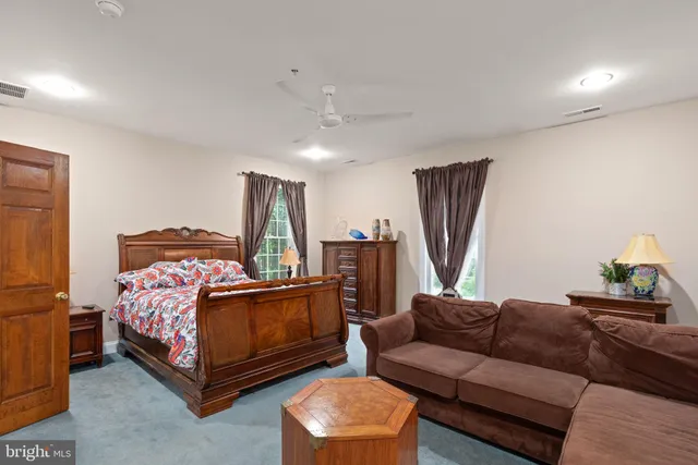 a bedroom with bed and a couch