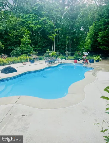a view of a swimming pool and a yard