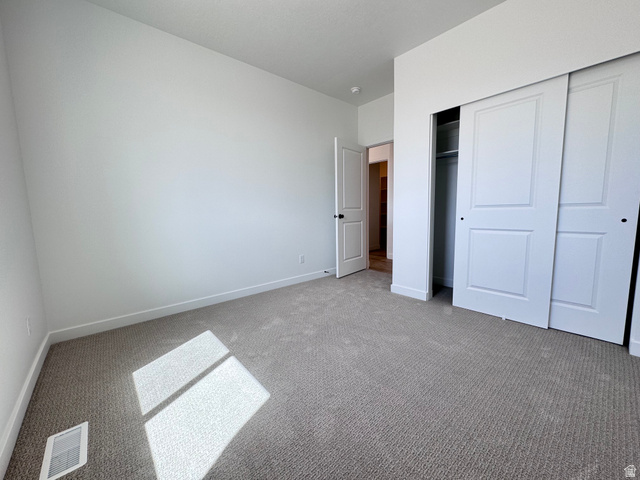 2633 Scarlet Road, Unit 259 Eagle Mountain, UT 84005 - Photo 14 of 30 Neutral tone carpeting extending throughout the room