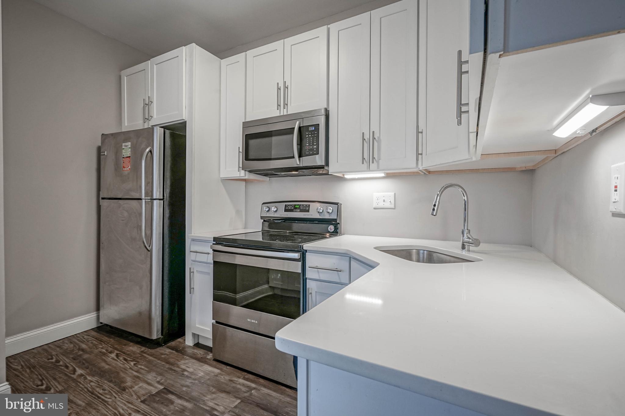 100 Aura Road, Unit 311 Clayton, NJ 08312 - Photo 12 of 29 a kitchen with stainless steel appliances granite countertop a refrigerator sink and stove
