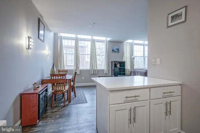 a view of a kitchen area with furniture and wooden floor