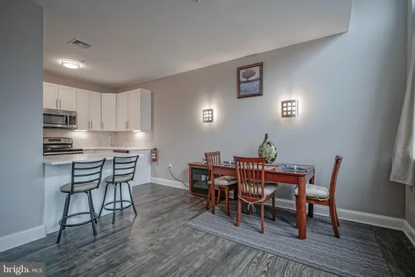 a dining room with furniture and wooden floor