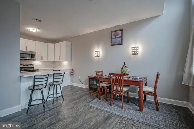 a dining room with furniture and wooden floor