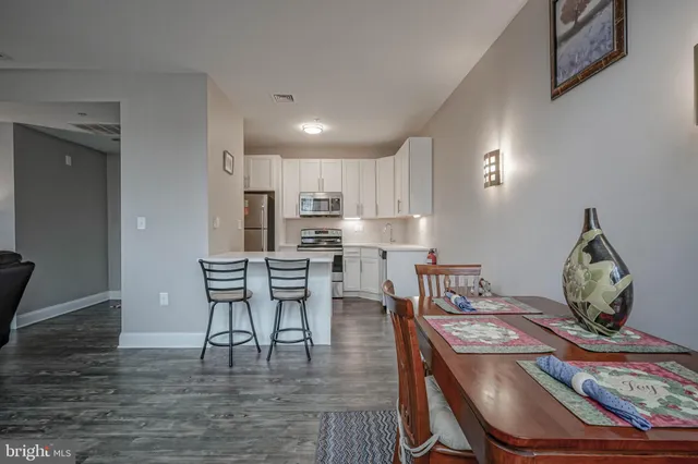 a dining room with furniture and wooden floor