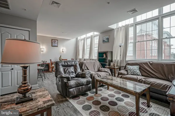 a living room with furniture a rug and a flat screen tv