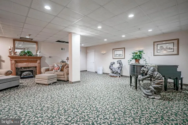 a living room with furniture and a mirror