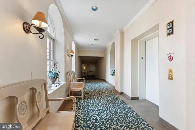 a view of a hallway to a livingroom and a couch