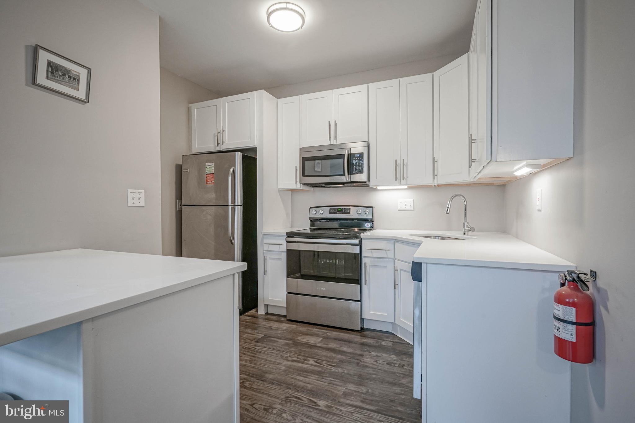 100 Aura Road, Unit 311 Clayton, NJ 08312 - Photo 10 of 29 a kitchen with a sink a stove and refrigerator