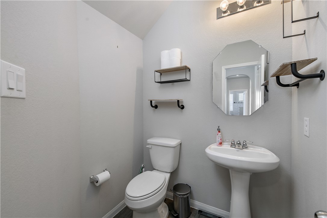 4705 Milagro Loop Bryan, TX 77807 - Photo 12 of 28 a bathroom with a toilet a sink and mirror