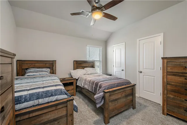 a bedroom with a bed and a television