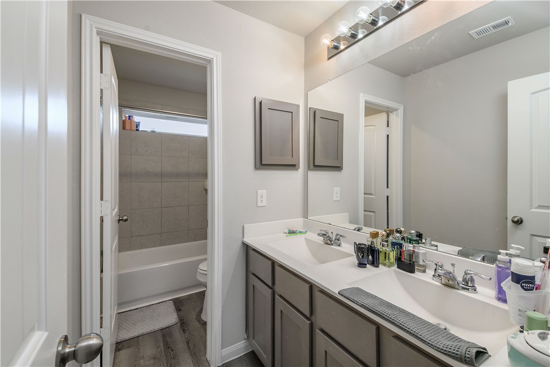 4705 Milagro Loop Bryan, TX 77807 - Photo 17 of 28 a bathroom with a sink and a mirror