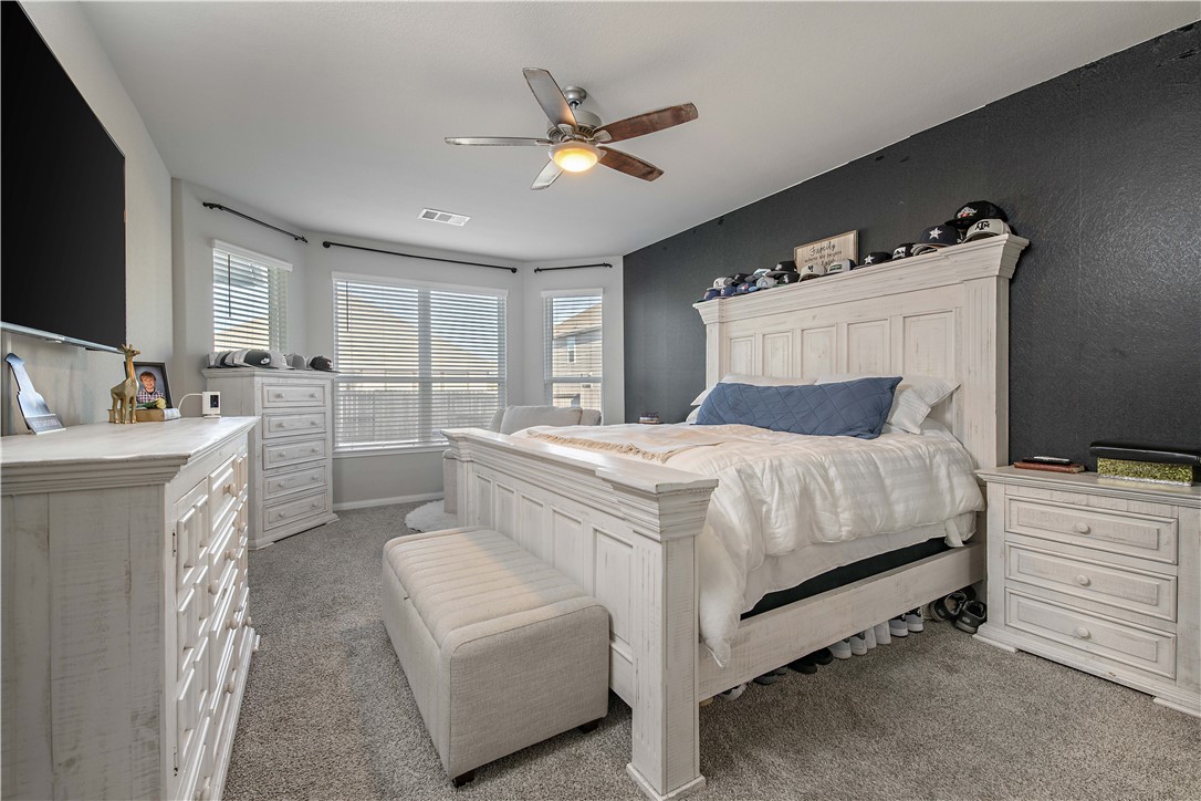 4705 Milagro Loop Bryan, TX 77807 - Photo 21 of 28 a bed room with a bed and a television