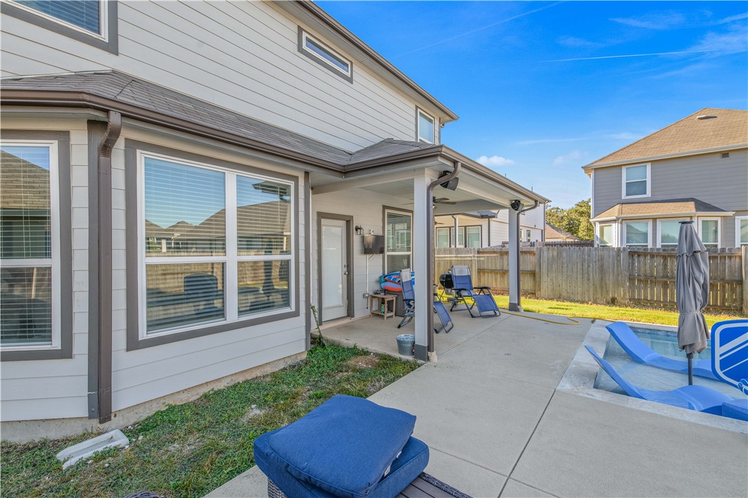 4705 Milagro Loop Bryan, TX 77807 - Photo 23 of 28 a view of pool with a lounge chair and floor to ceiling window