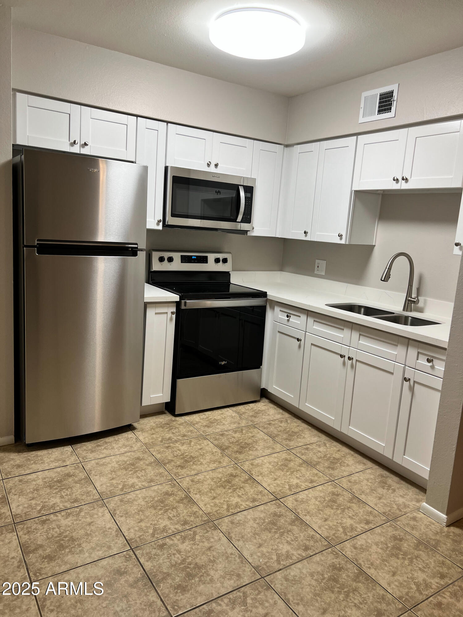 492 West 18th Avenue, Unit 2 Apache Junction, AZ 85120 - Photo 2 of 6 a kitchen with stainless steel appliances granite countertop a refrigerator sink and microwave