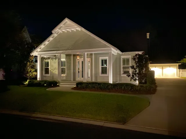 a view of a yard with plants and a bench