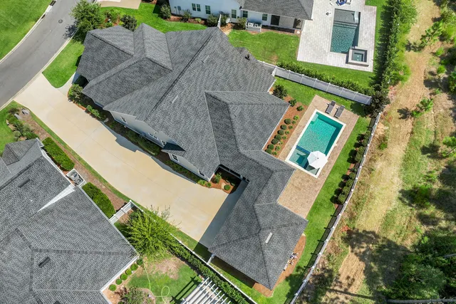 a view of a swimming pool with a patio and couches