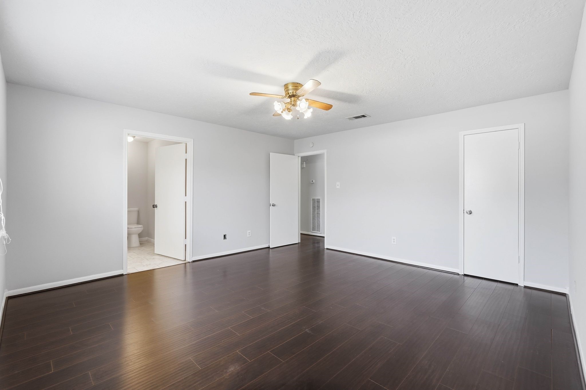 6807 Falling Waters Drive Spring, TX 77379 - Photo 12 of 22 a view of an empty room with wooden floor and a ceiling fan
