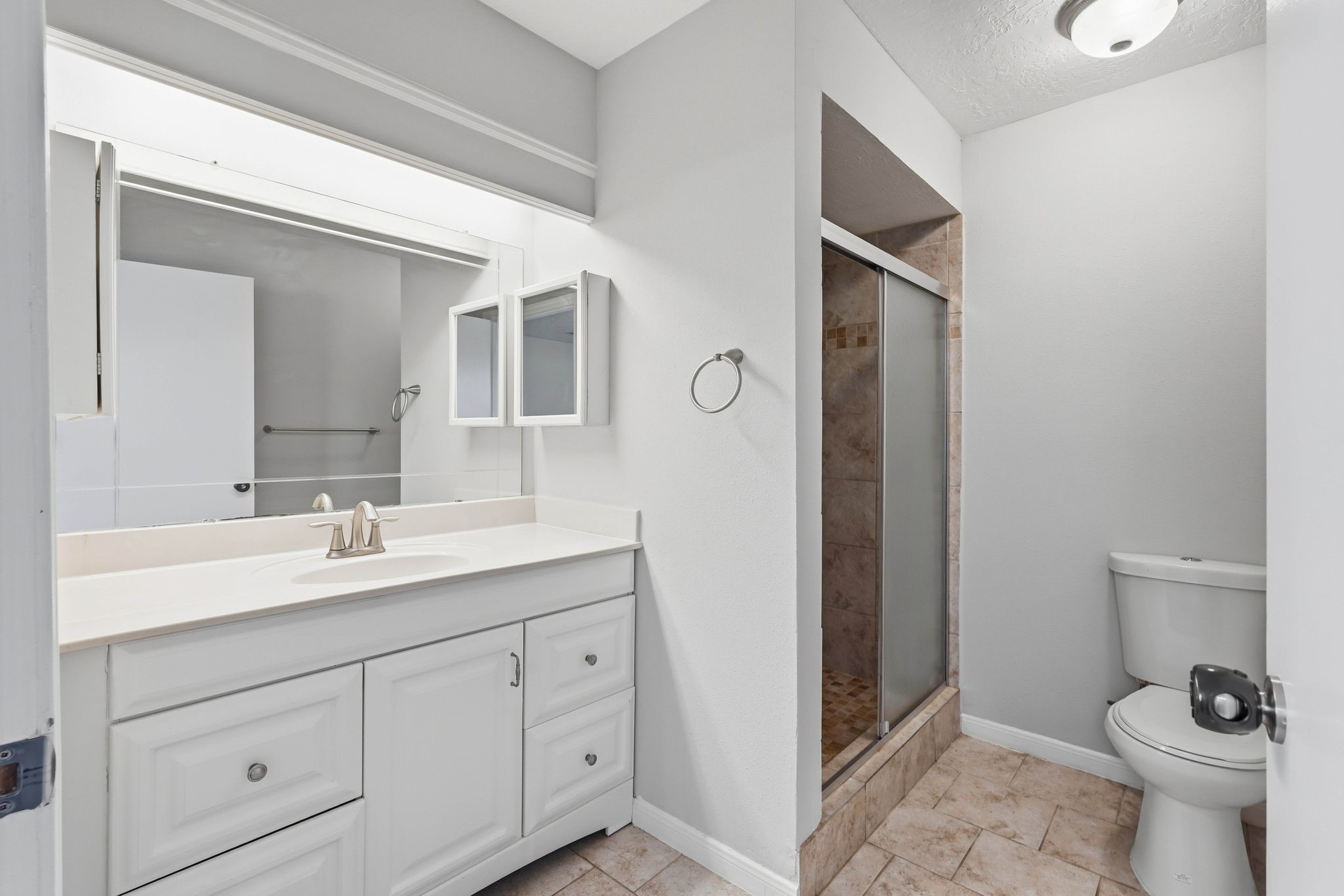 6807 Falling Waters Drive Spring, TX 77379 - Photo 13 of 22 a bathroom with a toilet sink and mirror